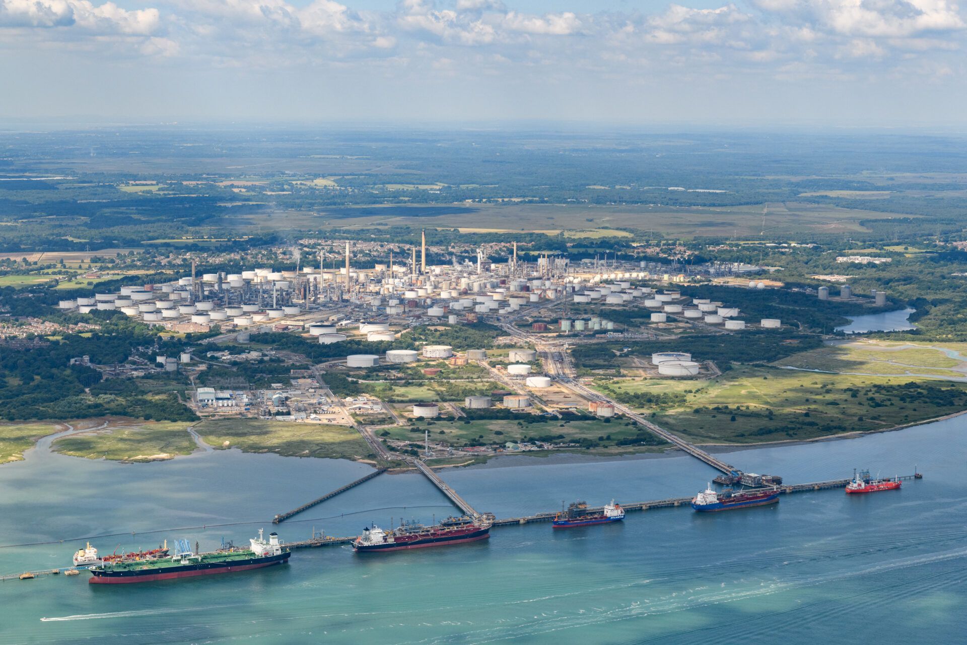 Aerial photo of Fawley Refinery and ships docked in Southampton water